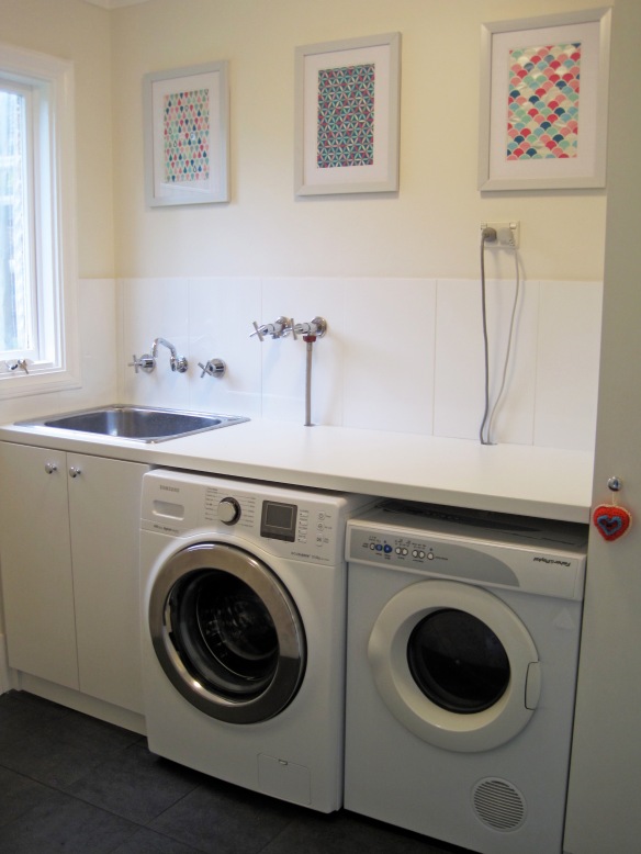laundry with trio of artwork on wall